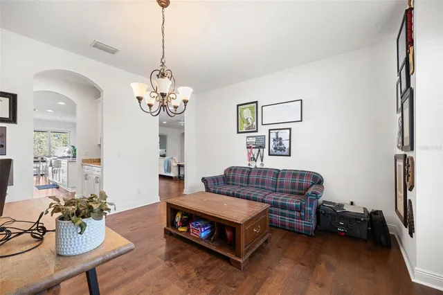 a living room with furniture and a chandelier