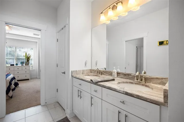 a bathroom with a granite countertop sink mirror and double