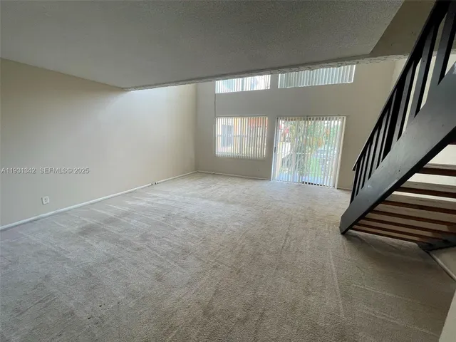 a view of a swimming pool with a patio and a garden