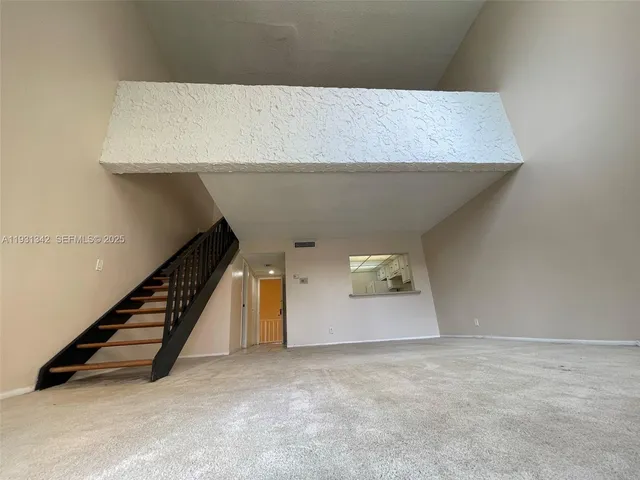 a view of an empty room with stairs