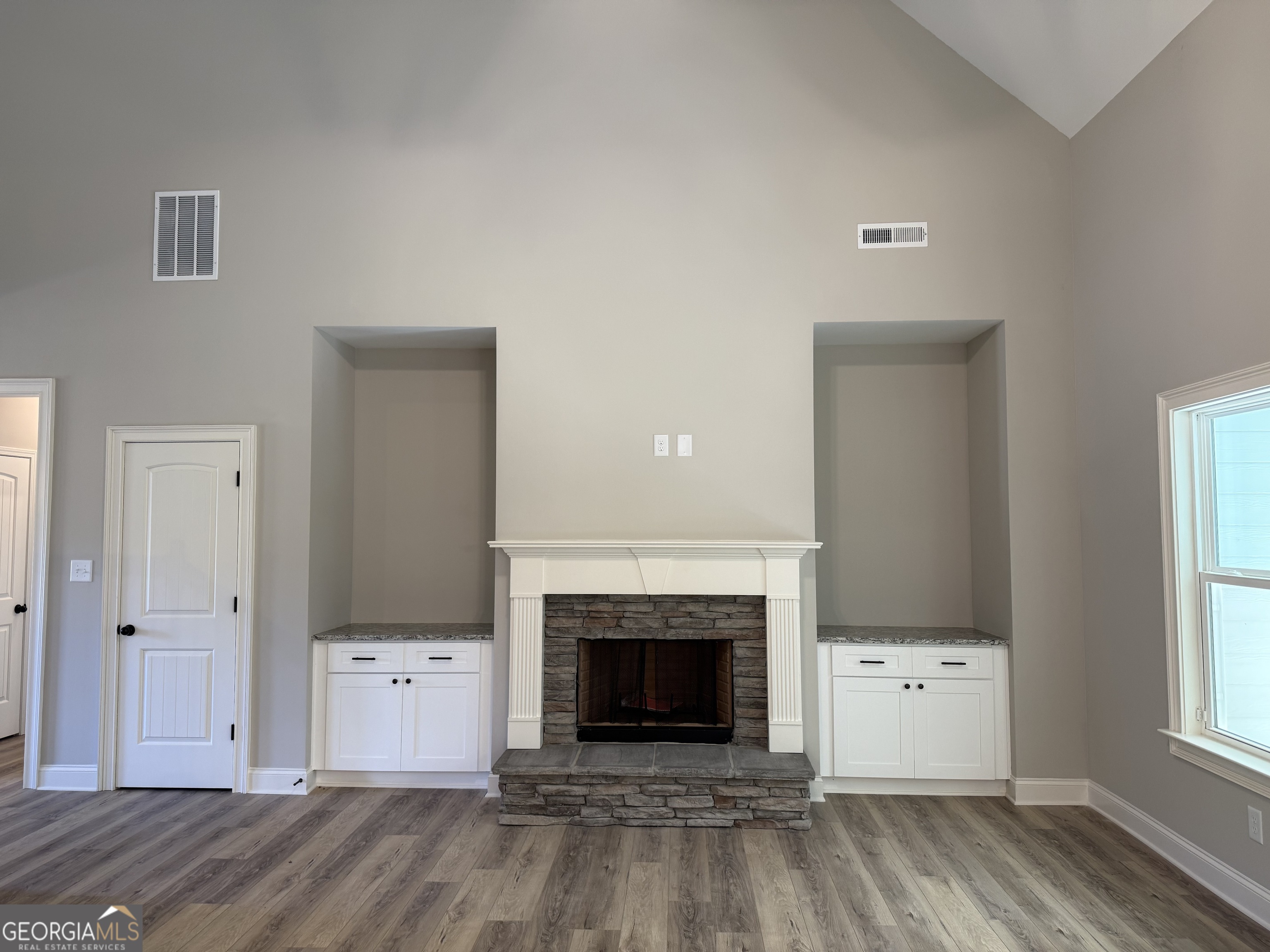 92 Commanche Circle Williamson, GA 30292 - Photo 12 of 53 an empty room with windows and fireplace