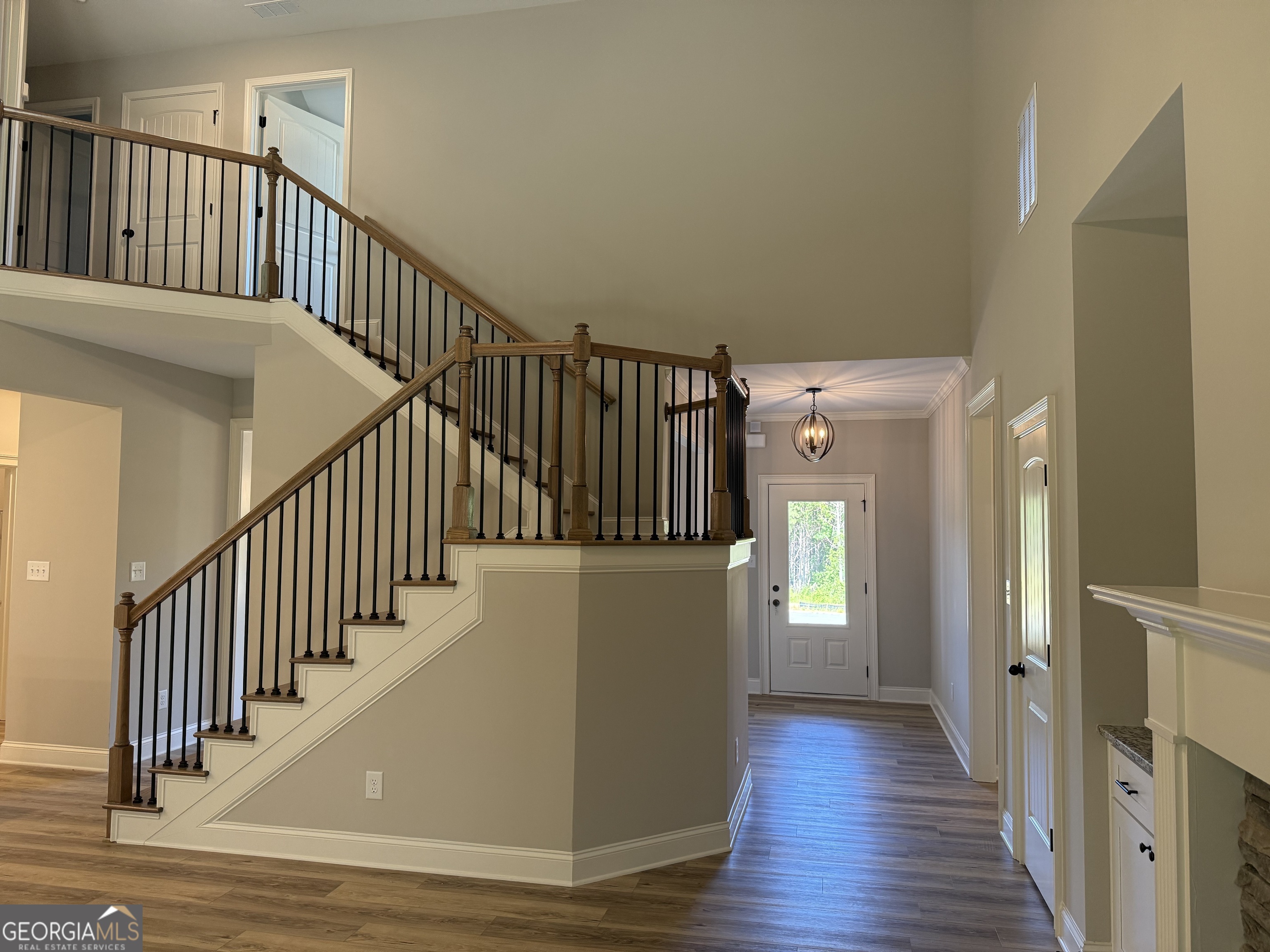 92 Commanche Circle Williamson, GA 30292 - Photo 13 of 53 a view of a hallway with wooden floor and staircase