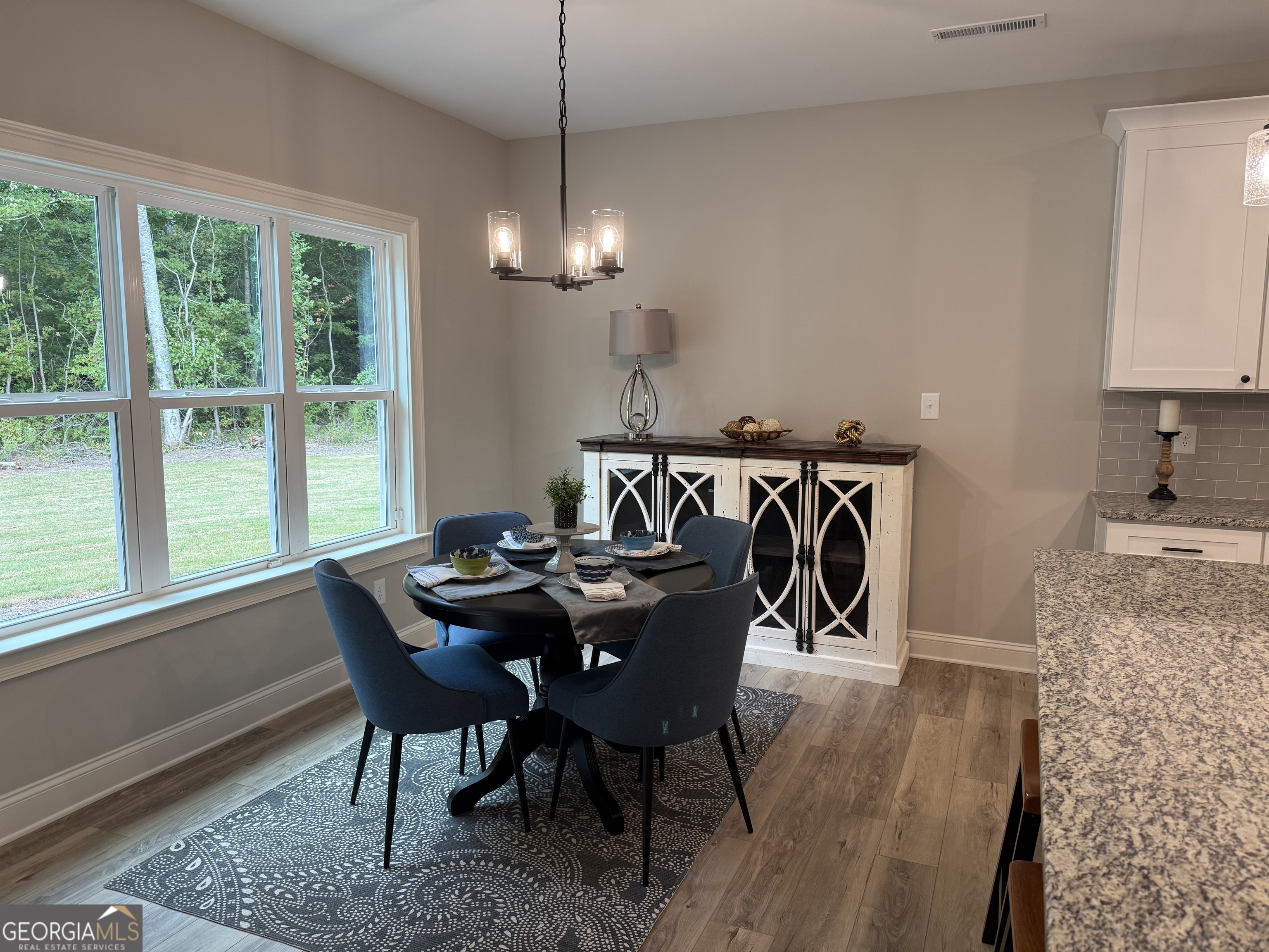 92 Commanche Circle Williamson, GA 30292 - Photo 23 of 53 a view of a dining room with furniture window and wooden floor