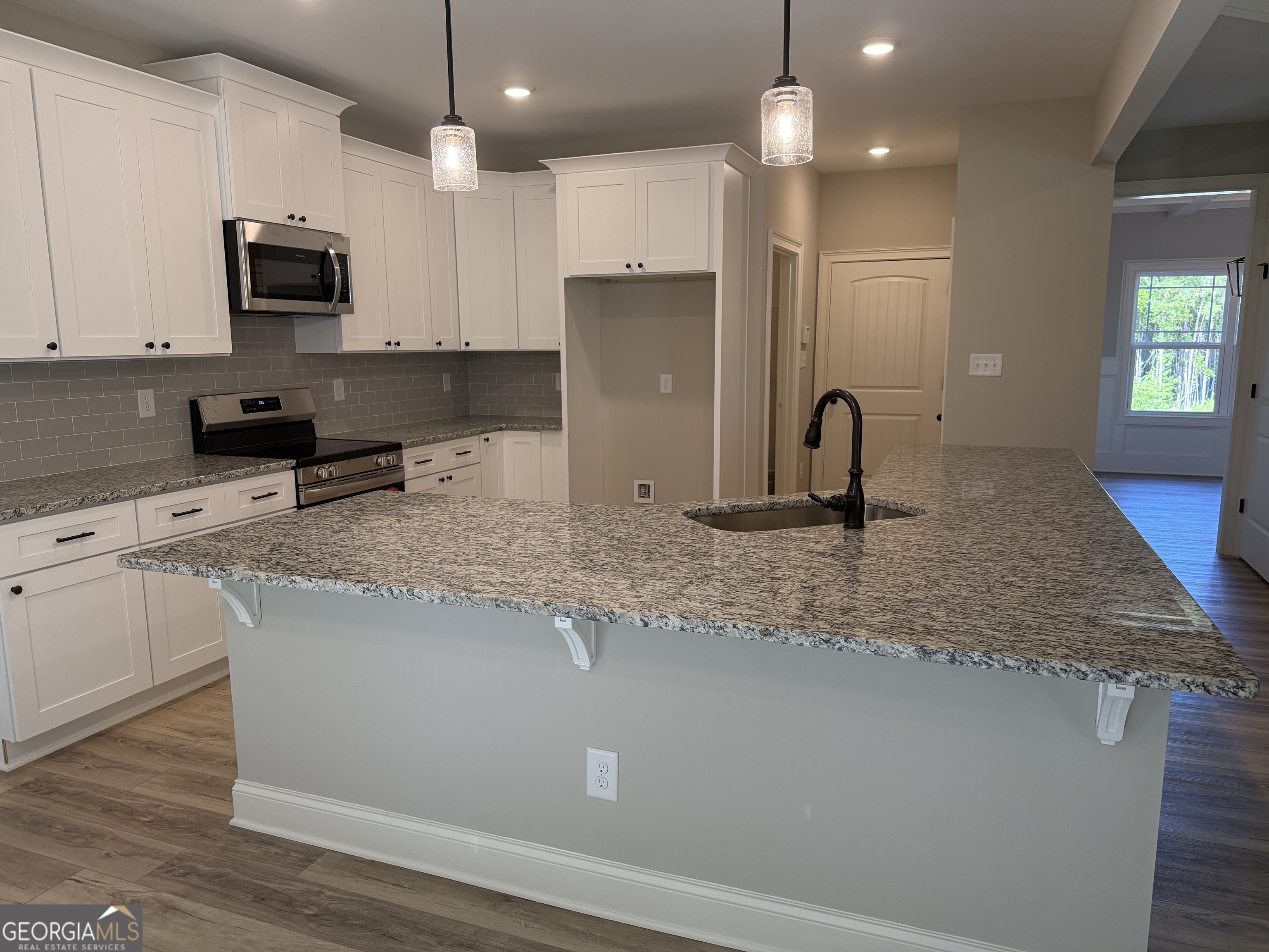 92 Commanche Circle Williamson, GA 30292 - Photo 24 of 53 a kitchen with stainless steel appliances granite countertop a sink a stove top oven a counter space and cabinets