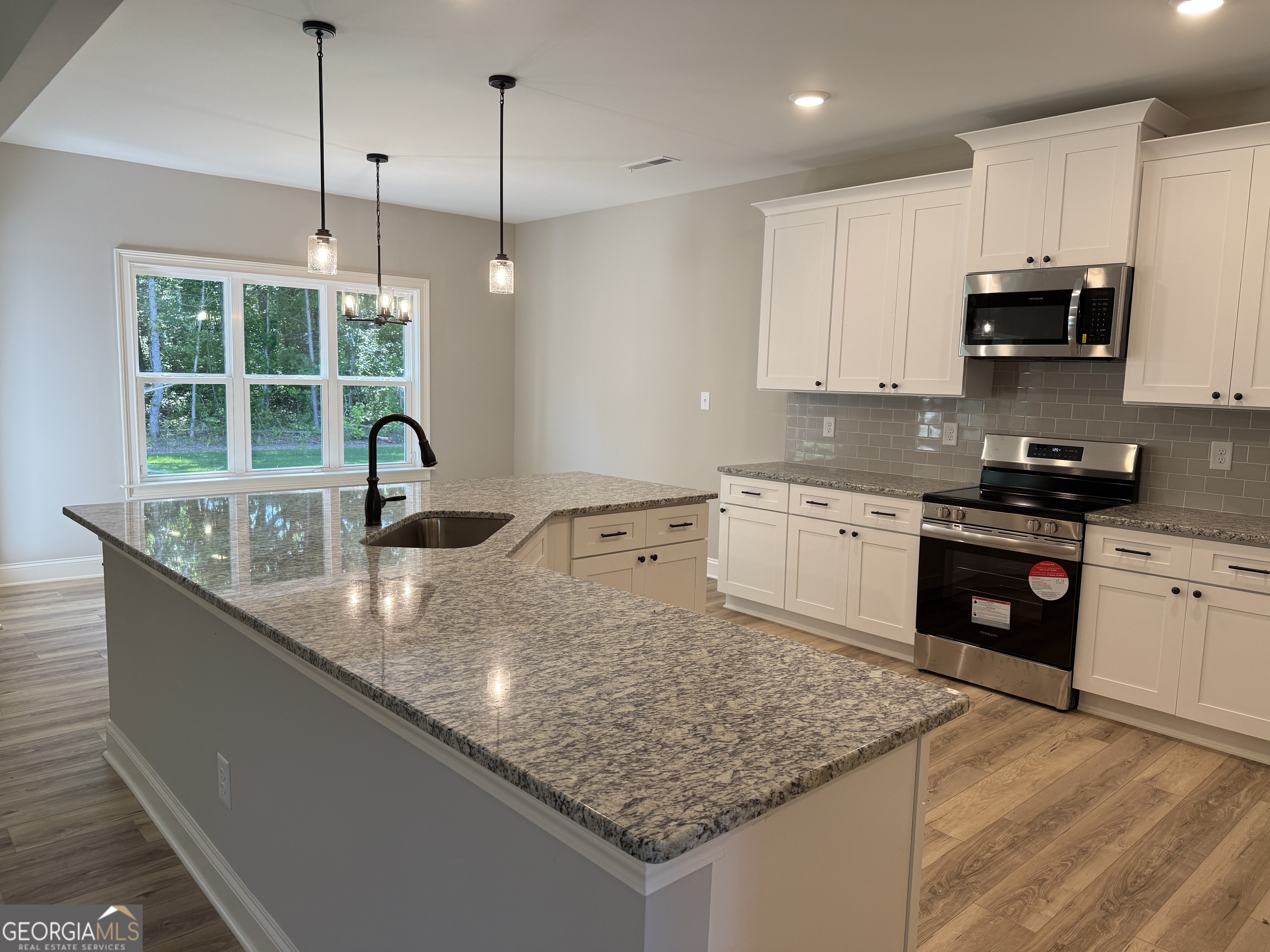 92 Commanche Circle Williamson, GA 30292 - Photo 26 of 53 a kitchen with stainless steel appliances granite countertop a sink a stove and a granite counter tops