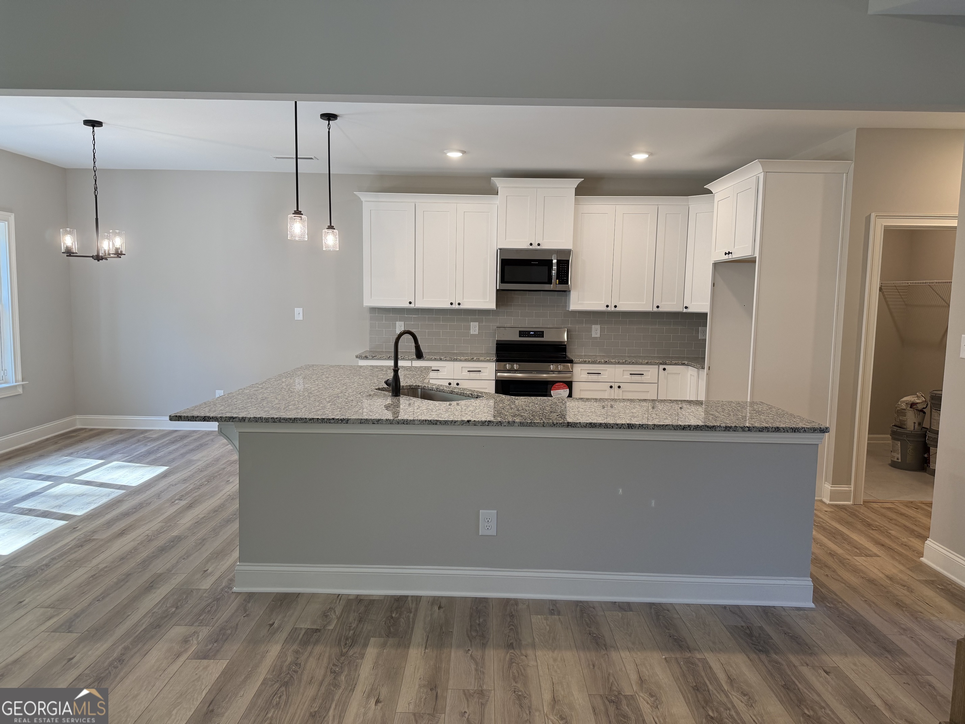 92 Commanche Circle Williamson, GA 30292 - Photo 27 of 53 a large kitchen with stainless steel appliances granite countertop a sink a stove and a refrigerator