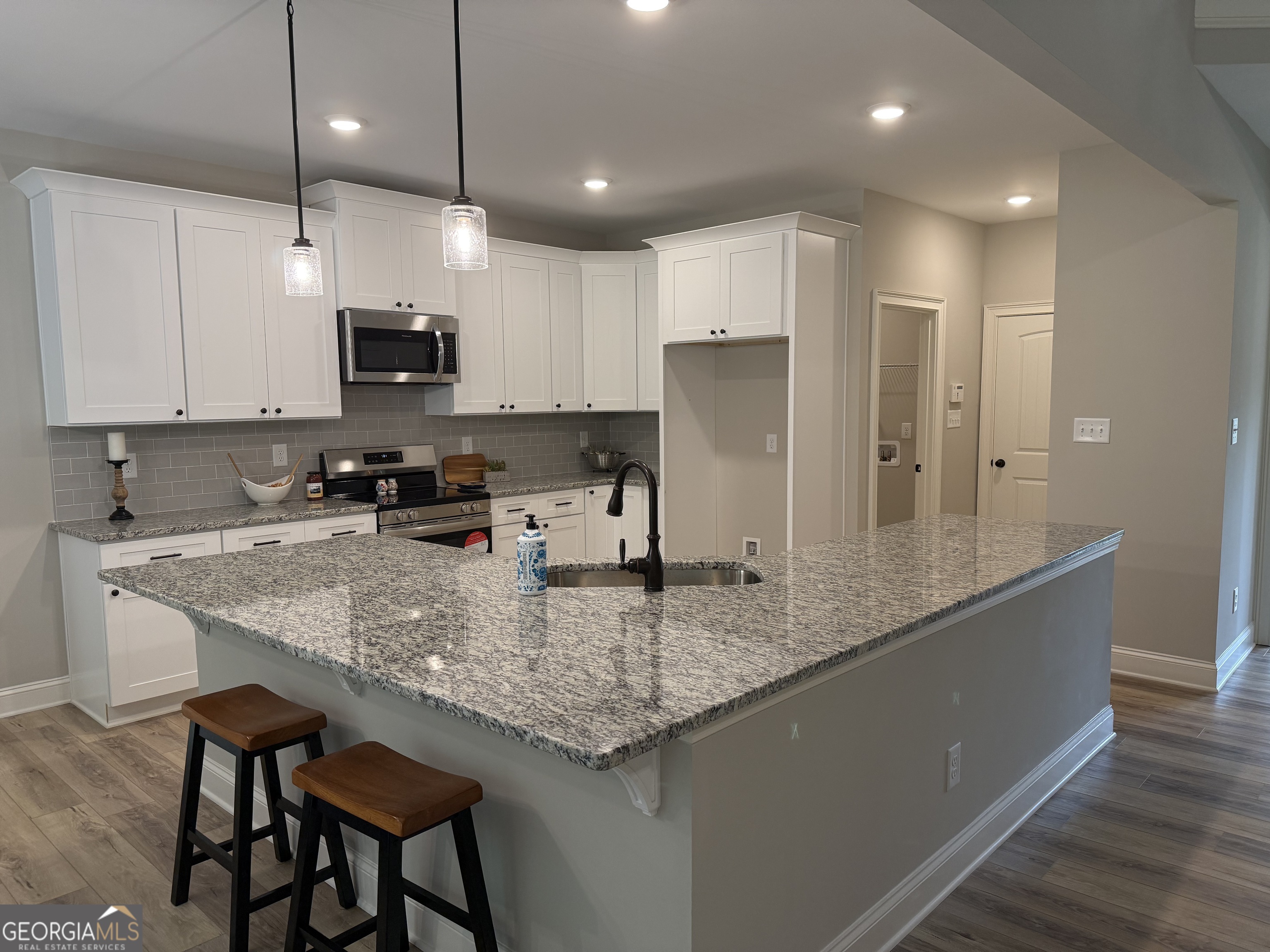 92 Commanche Circle Williamson, GA 30292 - Photo 28 of 53 a kitchen with stainless steel appliances granite countertop a sink refrigerator and microwave