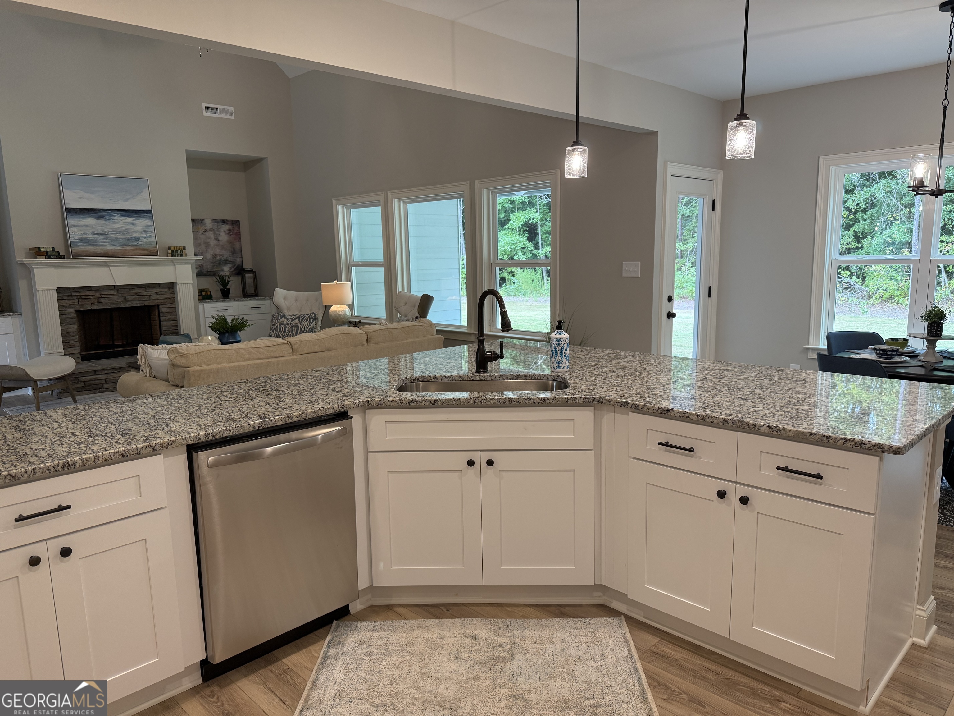 92 Commanche Circle Williamson, GA 30292 - Photo 30 of 53 a kitchen with granite countertop a sink white cabinets and a granite counter tops