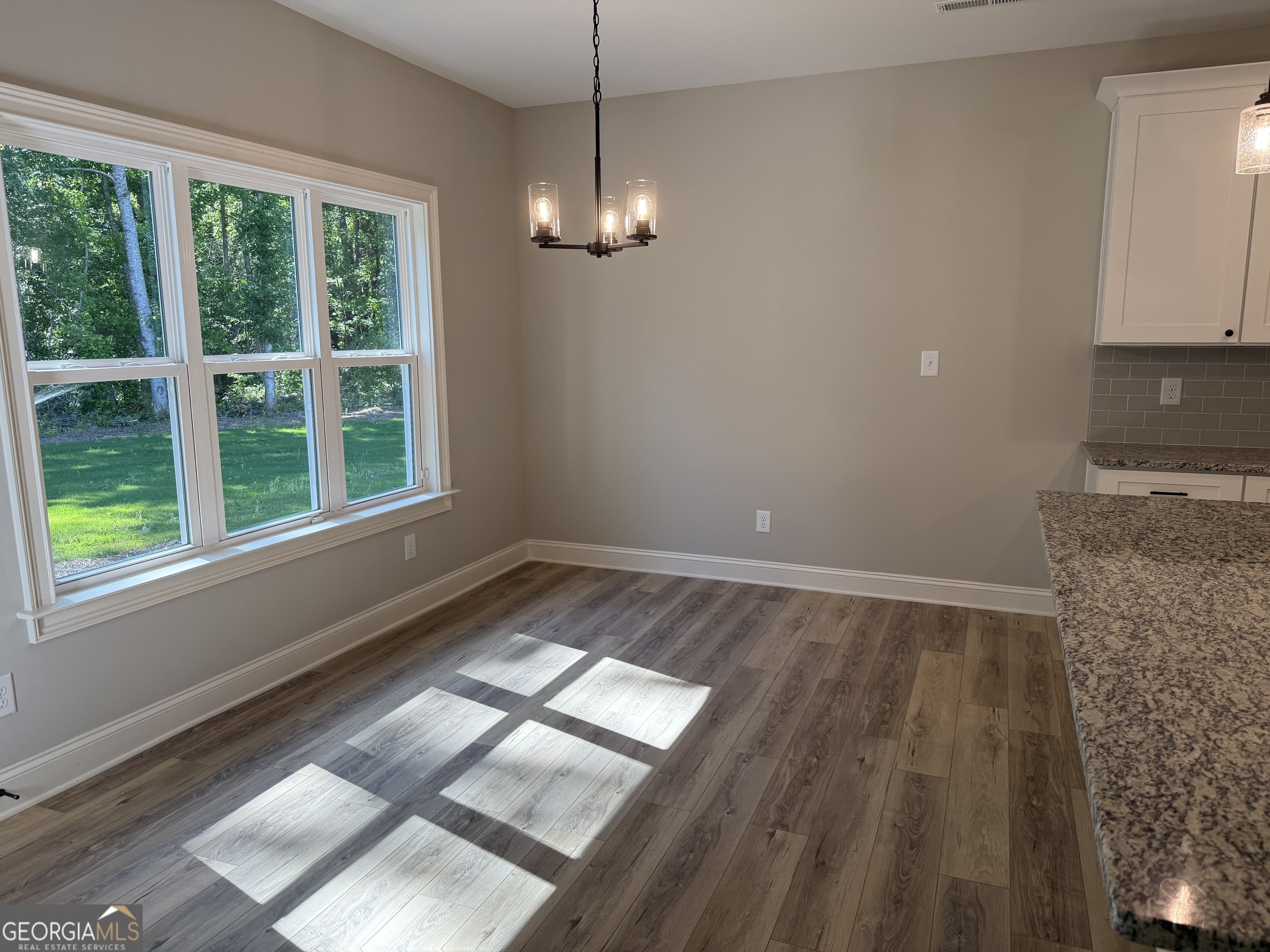 92 Commanche Circle Williamson, GA 30292 - Photo 31 of 53 a view of an empty room with wooden floor and a window