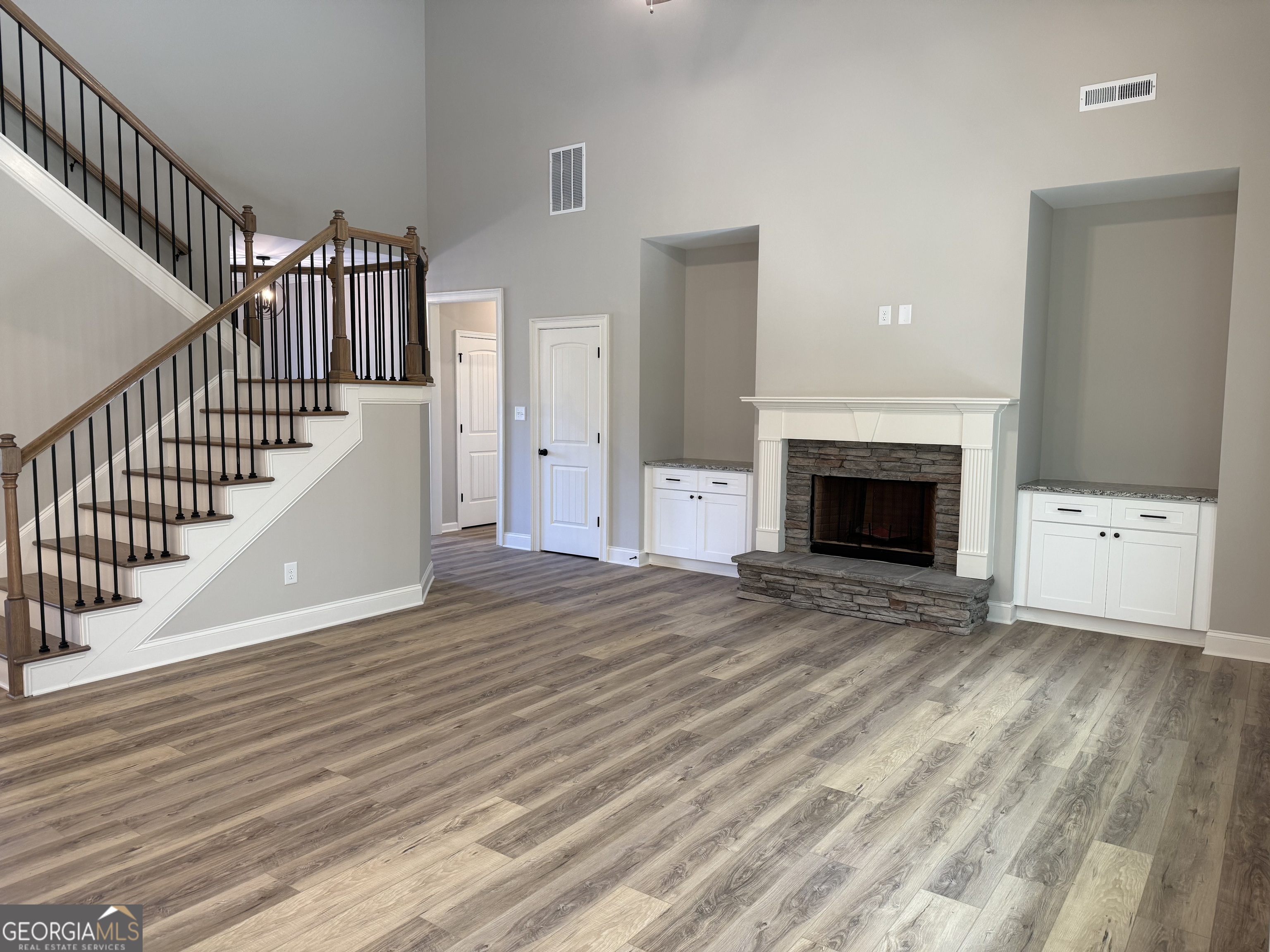92 Commanche Circle Williamson, GA 30292 - Photo 32 of 53 a view of an empty room with wooden floor and a fireplace