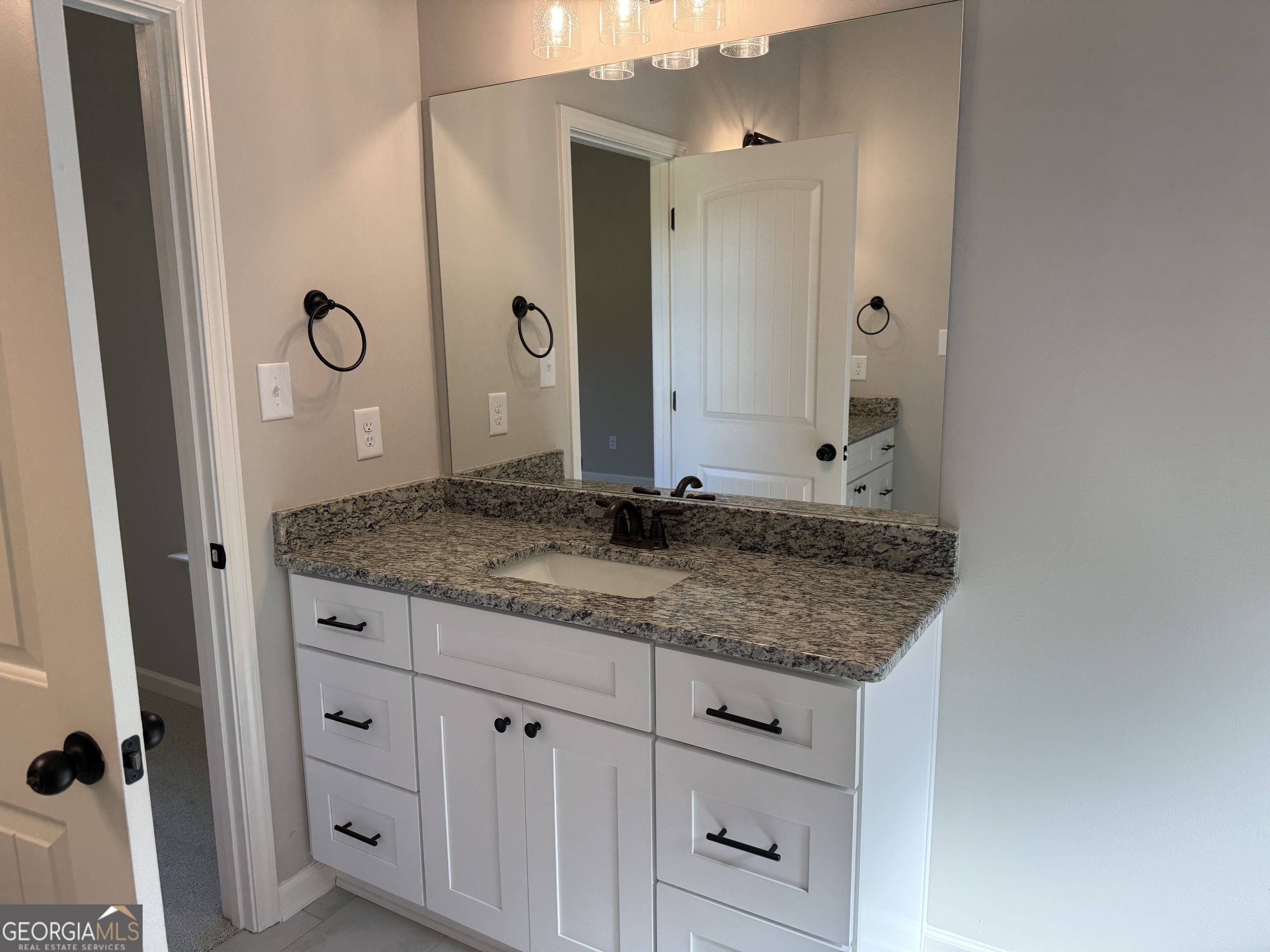 92 Commanche Circle Williamson, GA 30292 - Photo 42 of 53 a bathroom with a granite countertop sink and a mirror