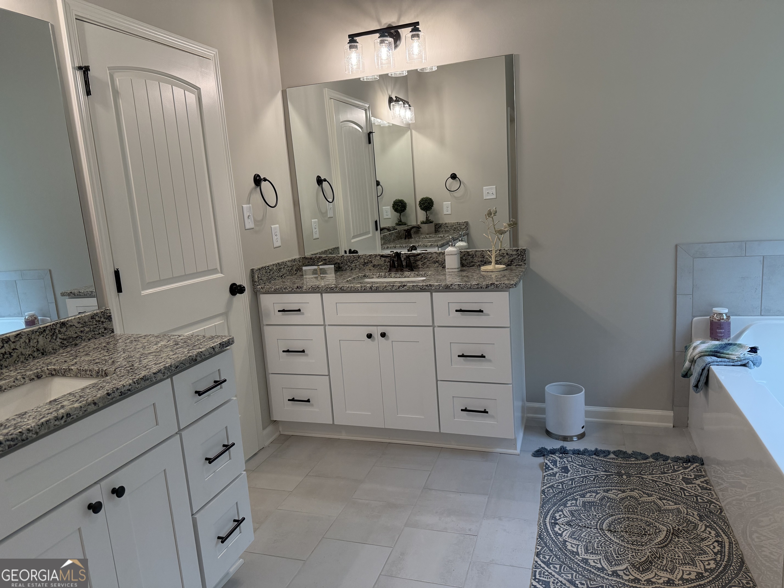 92 Commanche Circle Williamson, GA 30292 - Photo 43 of 53 a spacious bathroom with a granite countertop sink a toilet and a mirror