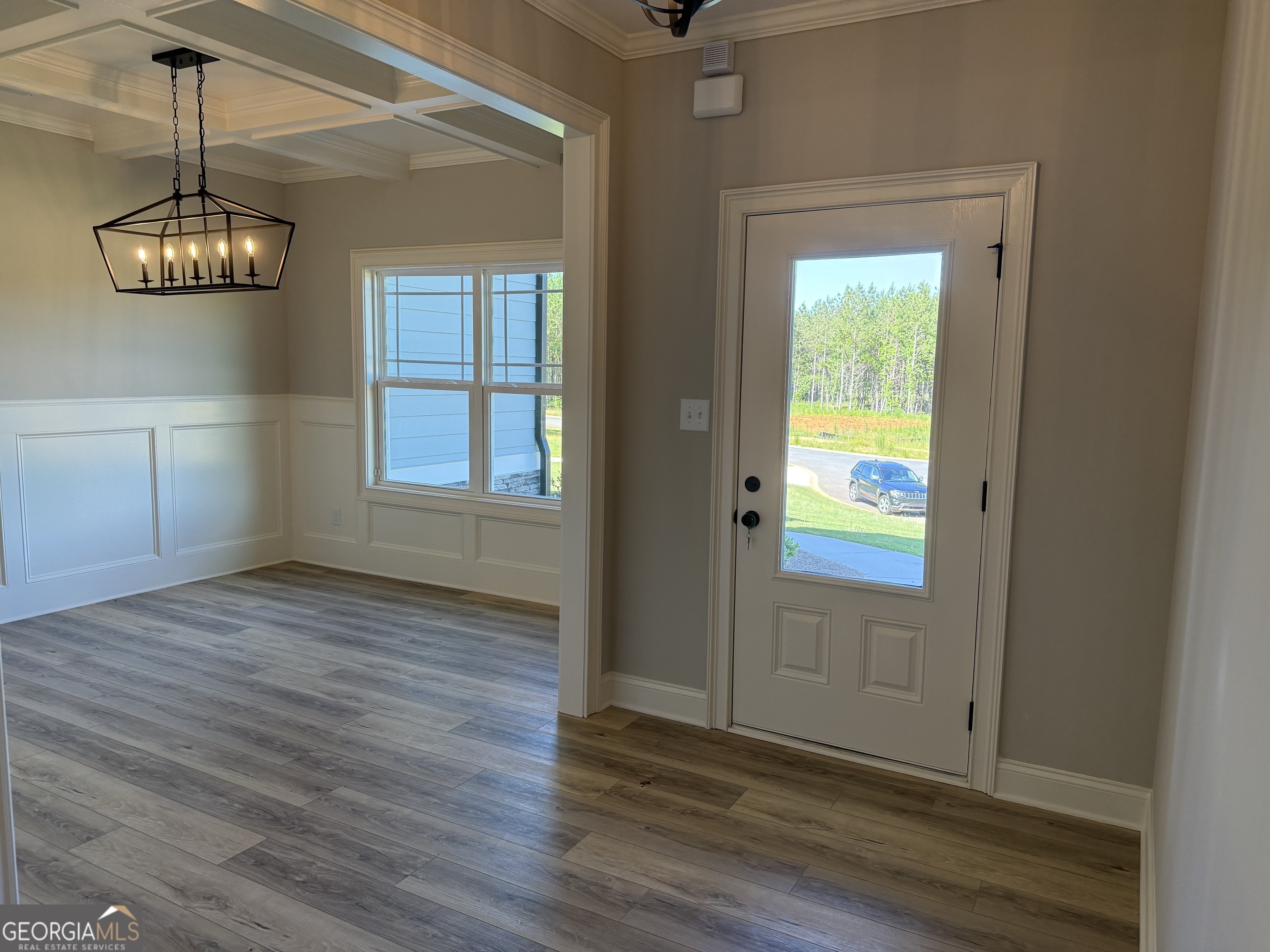92 Commanche Circle Williamson, GA 30292 - Photo 5 of 53 a view of an empty room with wooden floor and a window
