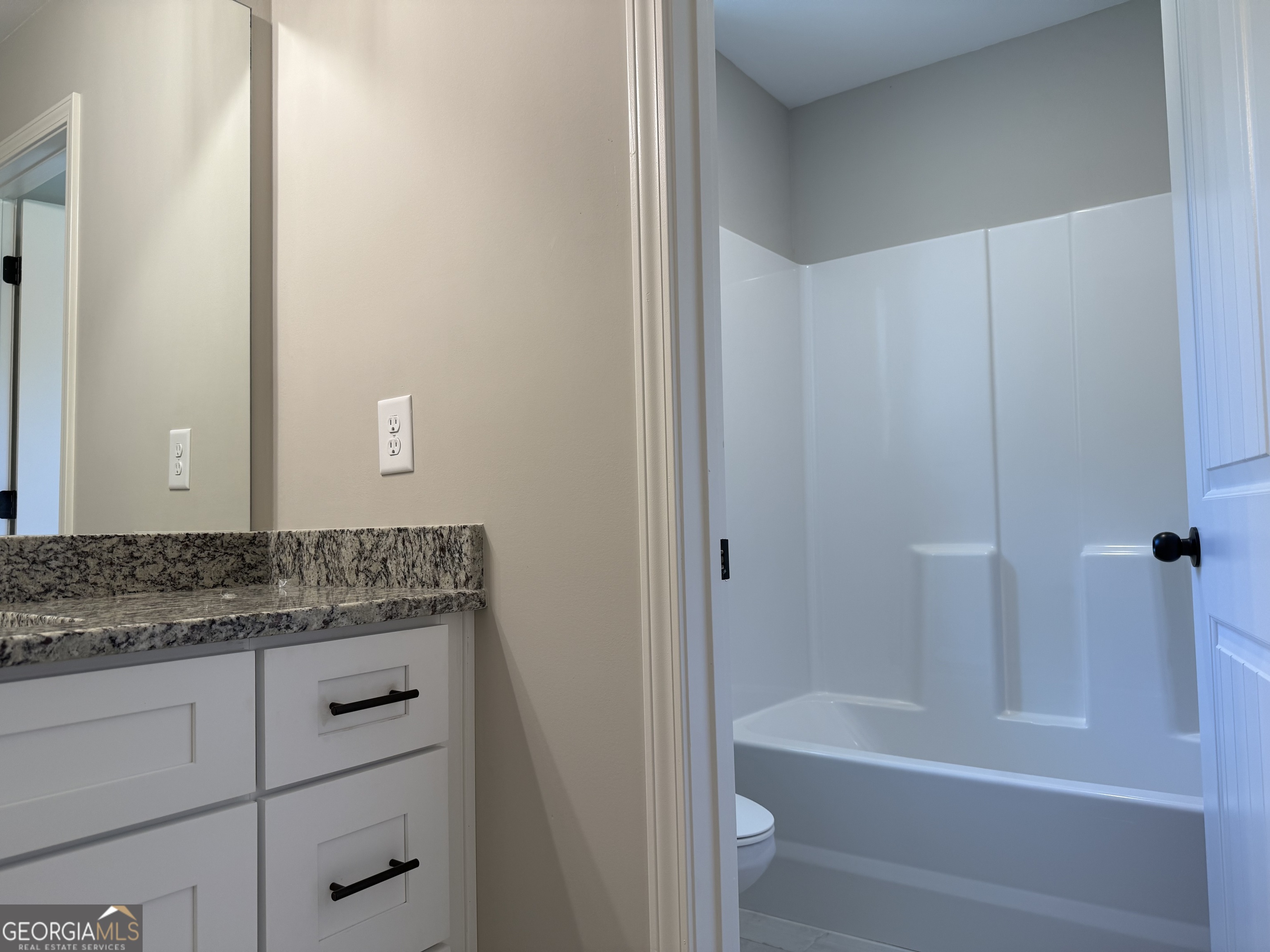 92 Commanche Circle Williamson, GA 30292 - Photo 52 of 53 a bathroom with a granite countertop sink a toilet and bathtub