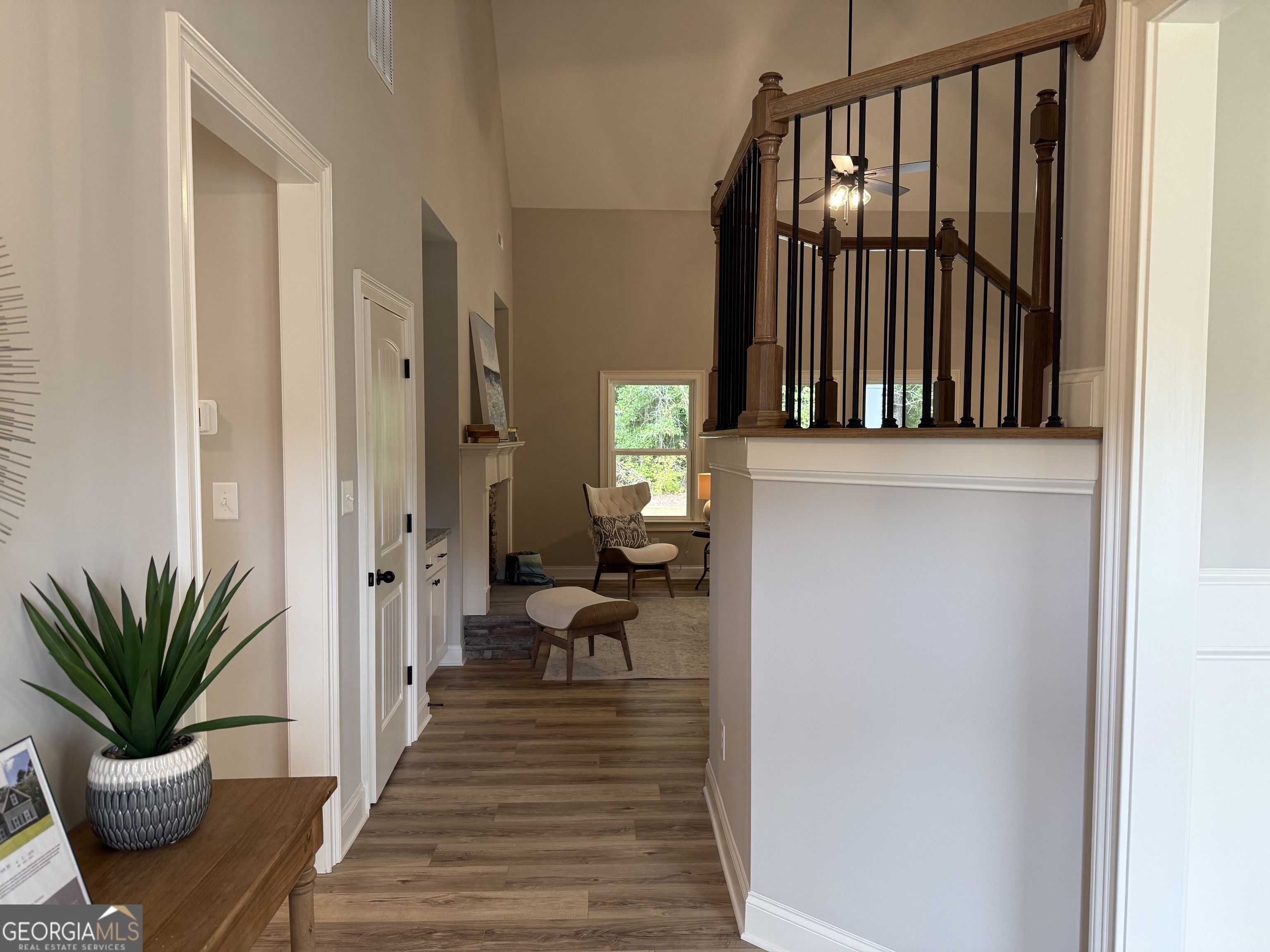 92 Commanche Circle Williamson, GA 30292 - Photo 6 of 53 a view of a hallway with wooden floor and a potted plant