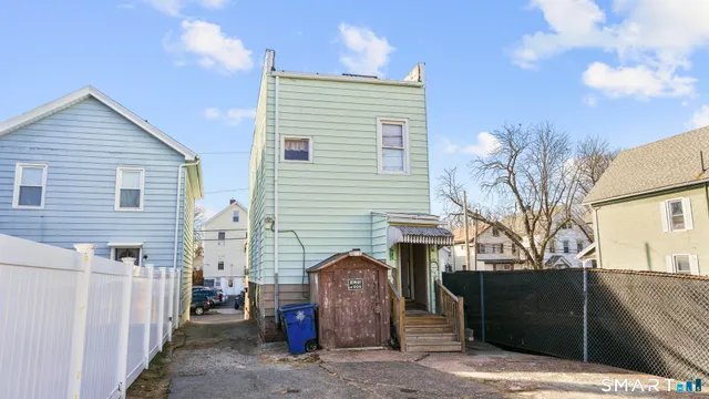 a view of a house with a patio and a garage