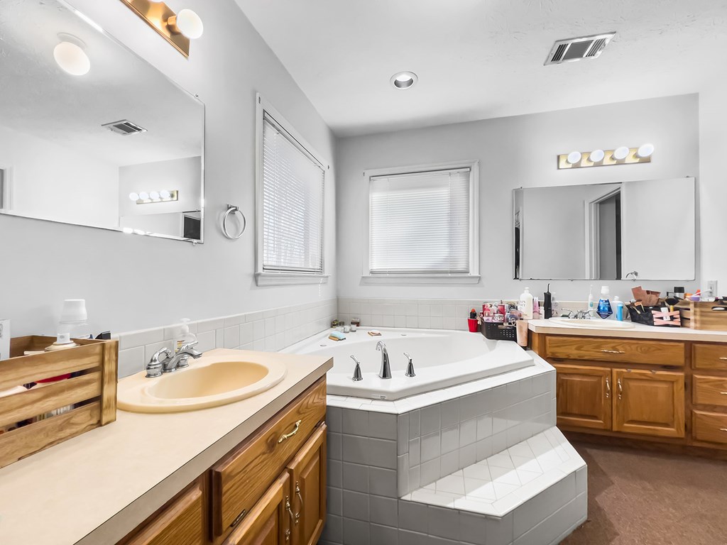 1085 Terry Lane Fortson, GA 31808 - Photo 17 of 21 a bathroom with a tub sink and mirror