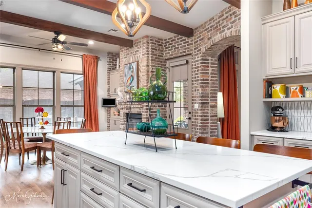 a kitchen with a sink and a large window