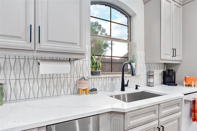 a kitchen with a sink and cabinets