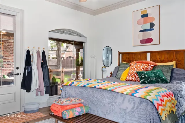 a bedroom with bed and a painting on the wall