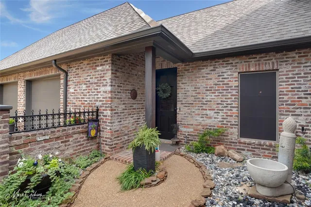 a front view of a house with potted plants
