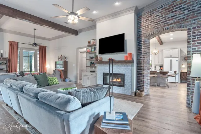 a living room with fireplace furniture and a flat screen tv