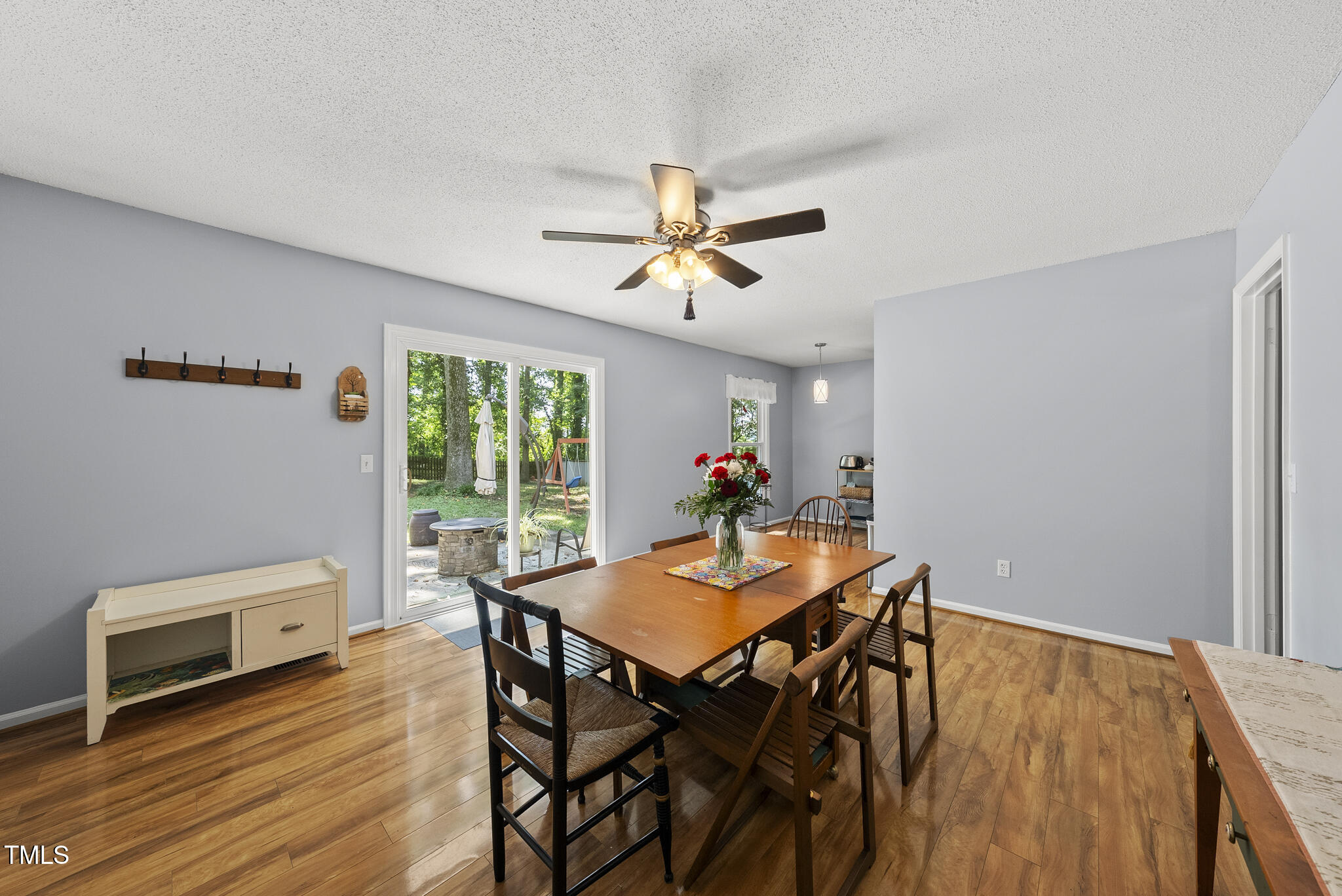 8613 Lobelia Street Raleigh, NC 27603 - Photo 12 of 25 a view of a dining room with furniture and wooden floor