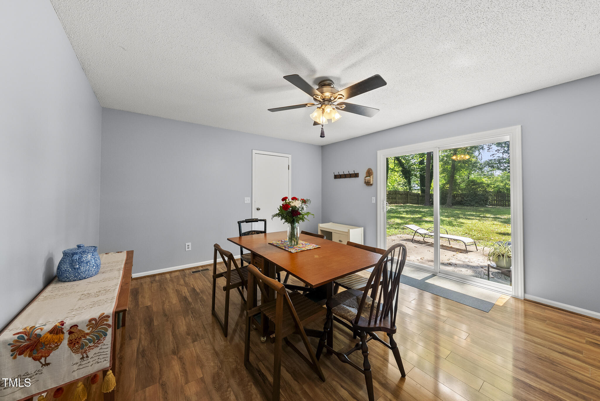 8613 Lobelia Street Raleigh, NC 27603 - Photo 13 of 25 a view of a dining room with furniture window and wooden floor