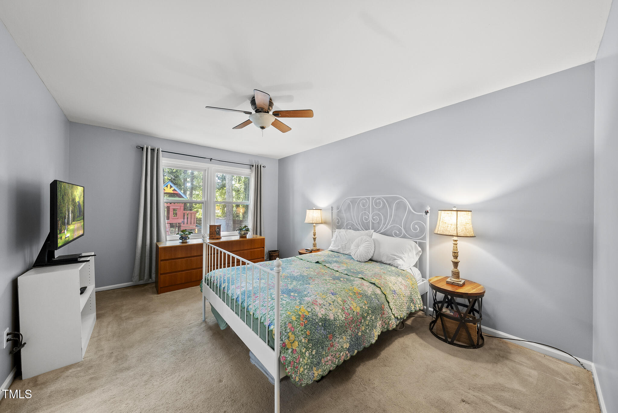 8613 Lobelia Street Raleigh, NC 27603 - Photo 18 of 25 a bedroom with a bed and a chandelier