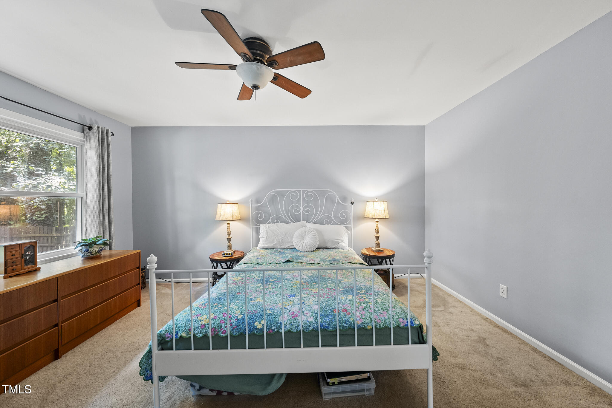 8613 Lobelia Street Raleigh, NC 27603 - Photo 19 of 25 a bed room with a bed window and a night stand