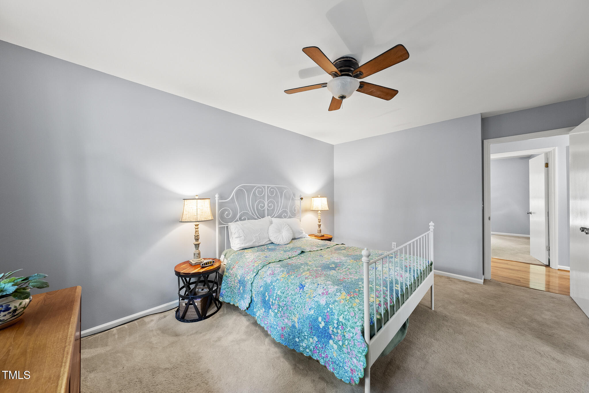 8613 Lobelia Street Raleigh, NC 27603 - Photo 20 of 25 a bedroom with a bed and a ceiling fan
