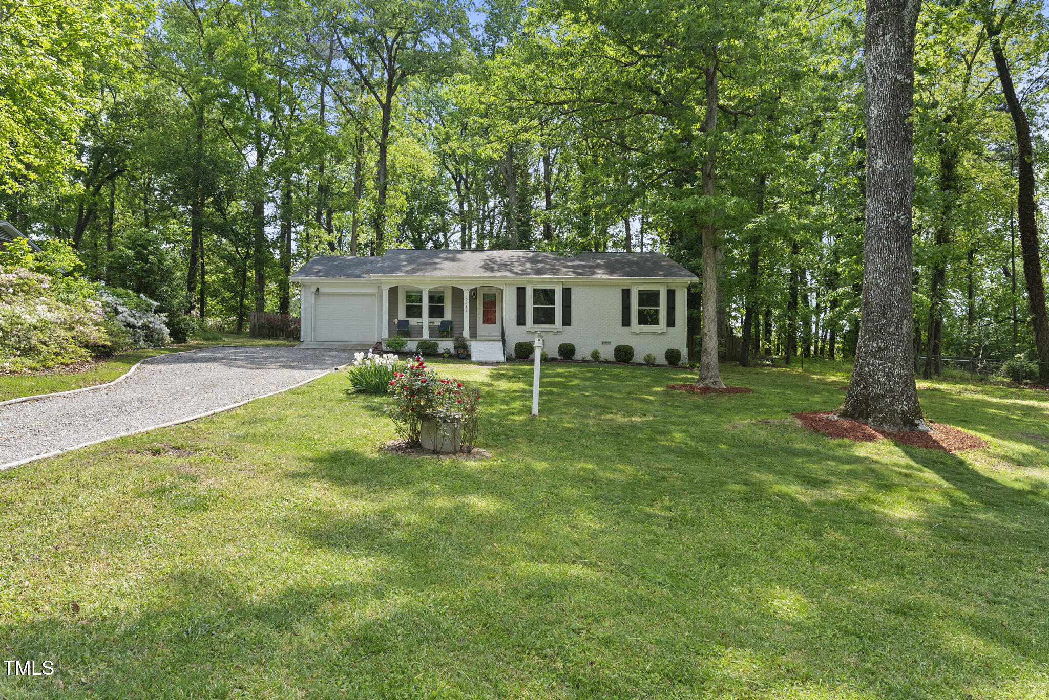 8613 Lobelia Street Raleigh, NC 27603 - Photo 3 of 25 front view of a house with a yard table and chairs