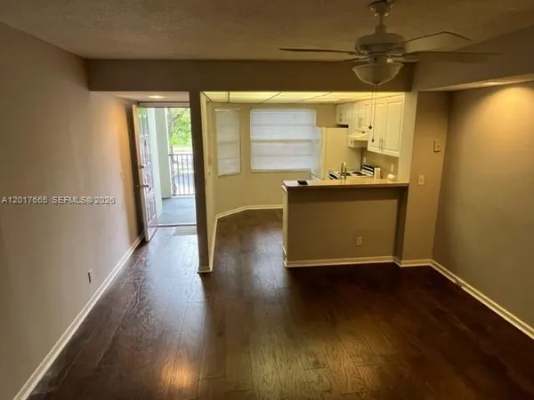 a living room with wooden floor and furniture