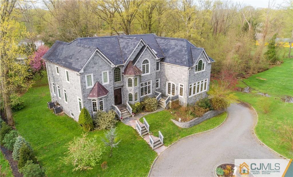 64 Stafford Road Colonia, NJ 07067 - Photo 1 of 25 a aerial view of a house next to a big yard and large trees