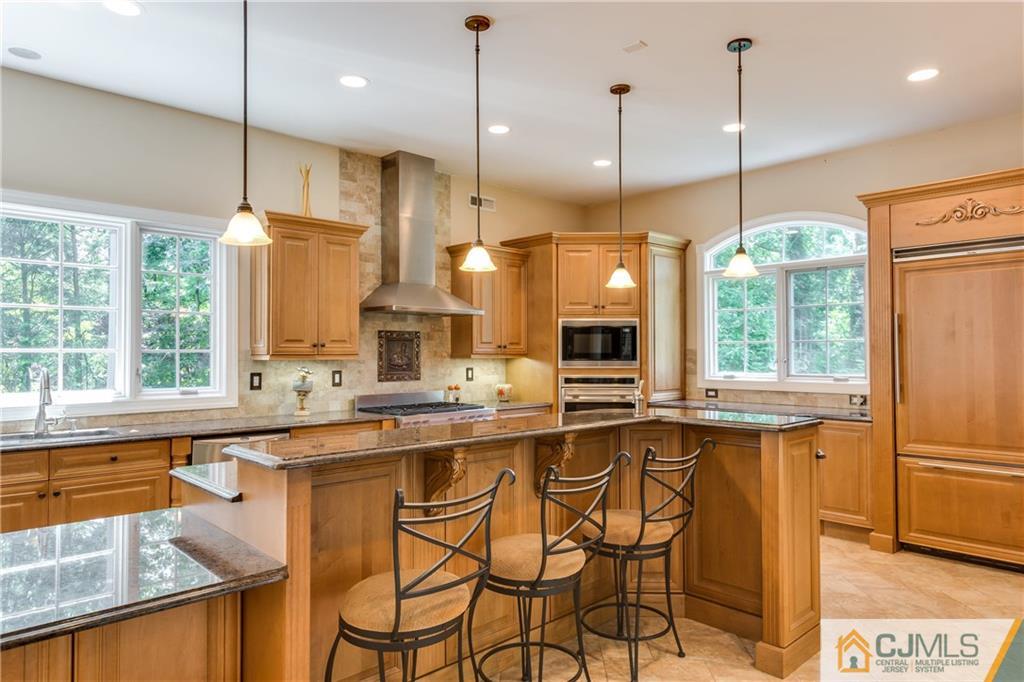 64 Stafford Road Colonia, NJ 07067 - Photo 11 of 25 a kitchen with stainless steel appliances granite countertop a stove a sink island and a wooden cabinets