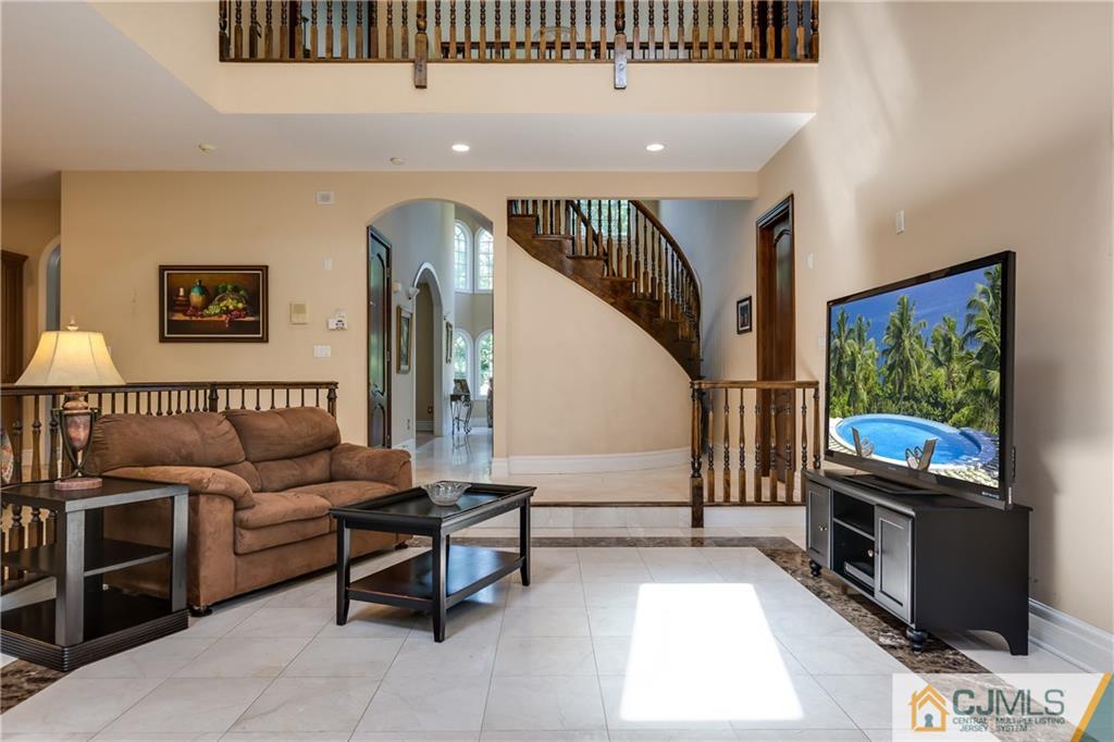 64 Stafford Road Colonia, NJ 07067 - Photo 14 of 25 a living room with furniture a flat screen tv and a fireplace