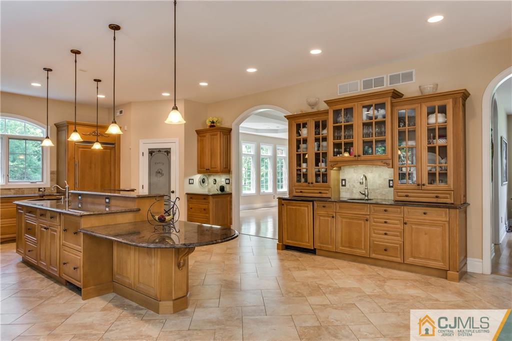 64 Stafford Road Colonia, NJ 07067 - Photo 8 of 25 a large kitchen with kitchen island a stove a sink a center island a table and chairs