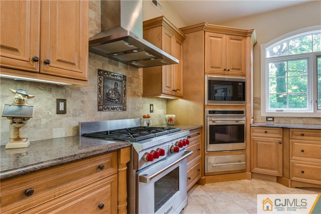 64 Stafford Road Colonia, NJ 07067 - Photo 10 of 25 a kitchen with granite countertop a stove and a sink