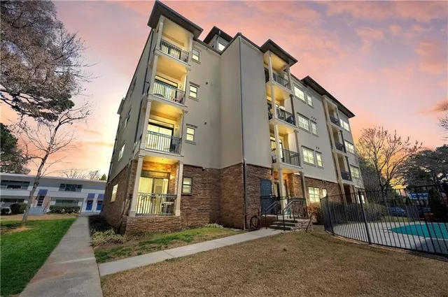 a view of a brick building next to a yard