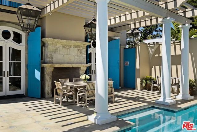 a view of a living room filled with furniture and floor to ceiling windows