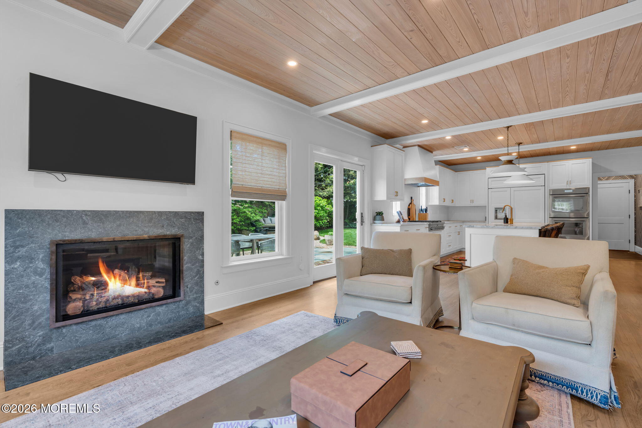 22 1st Street Rumson, NJ 07760 - Photo 14 of 44 a living room with furniture a fireplace and a flat screen tv