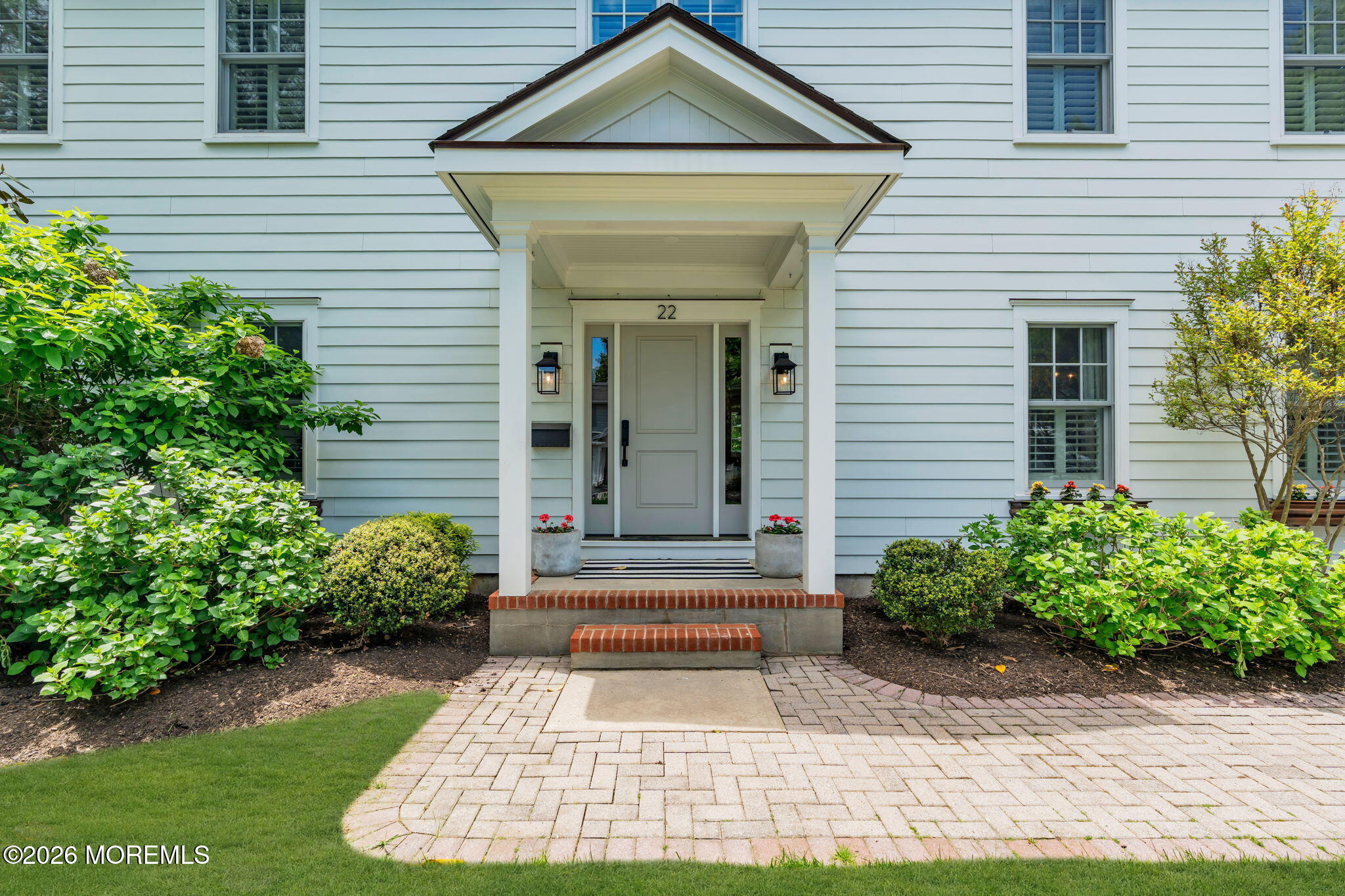 22 1st Street Rumson, NJ 07760 - Photo 3 of 44 a front view of a house with garden