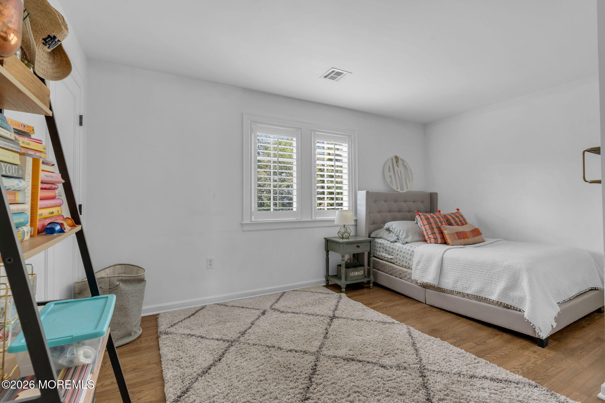 22 1st Street Rumson, NJ 07760 - Photo 34 of 44 a bedroom with a bed and a chair
