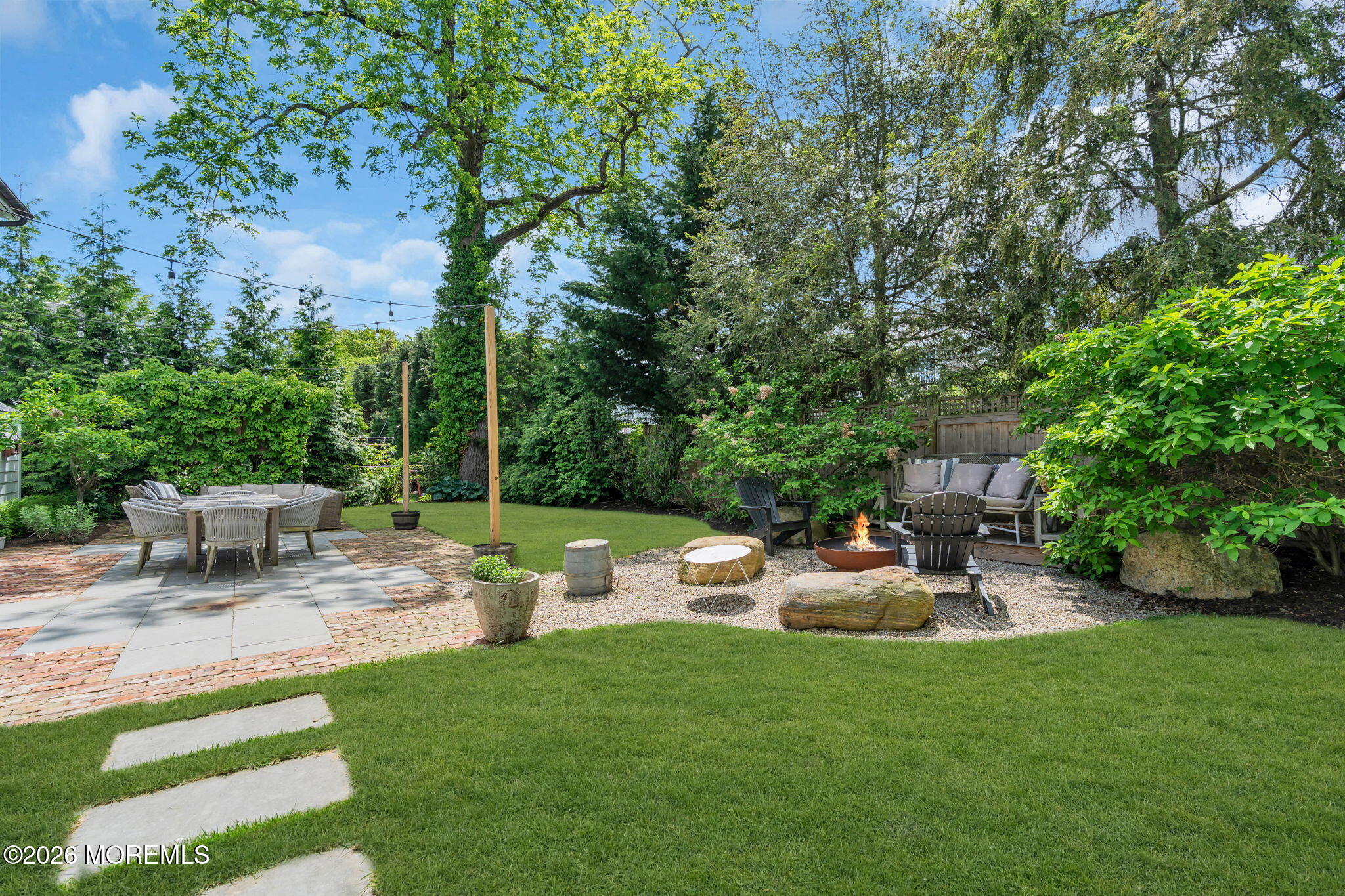 22 1st Street Rumson, NJ 07760 - Photo 36 of 44 a backyard of a house with table and chairs