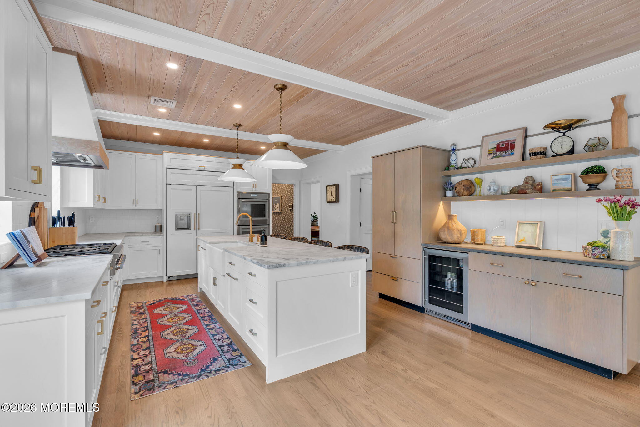 22 1st Street Rumson, NJ 07760 - Photo 7 of 44 a large white kitchen with stainless steel appliances granite countertop a lot of counter space and wooden floors