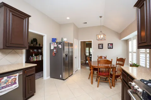 a kitchen with stainless steel appliances sink stove and cabinets