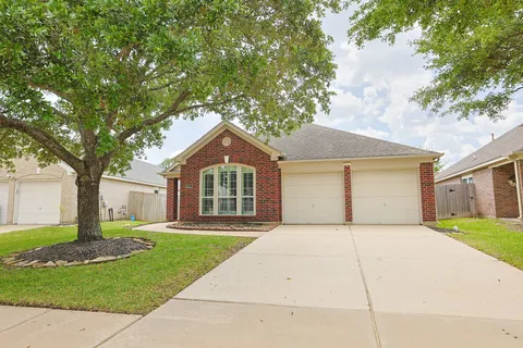 a front view of a house with a yard and fence