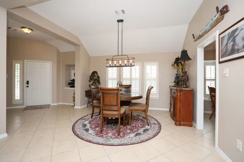 a view of a kitchen with dining area closet area and windows