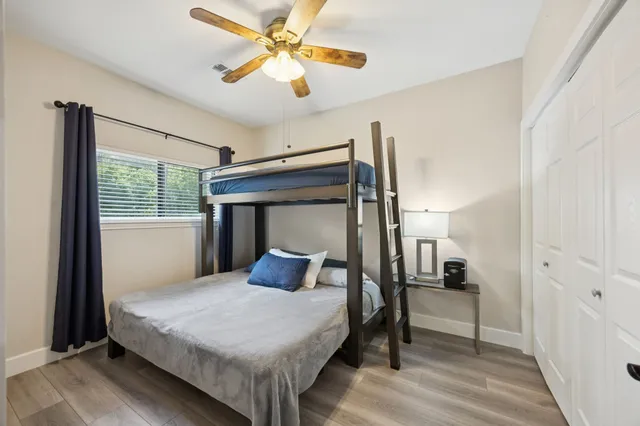a bedroom with a bed and a television on dresser