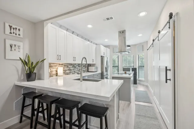 a kitchen that has a stove and a table in it